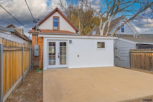 rear view of house featuring a patio and french doors