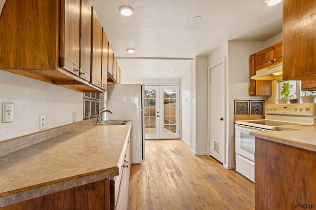 kitchen with sink, light hardwood / wood-style floors, french doors, and white range with electric cooktop