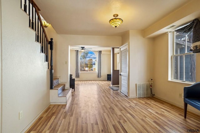 corridor with light hardwood / wood-style floors