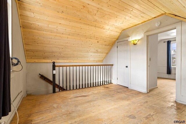 additional living space with lofted ceiling, wooden ceiling, and light wood-type flooring