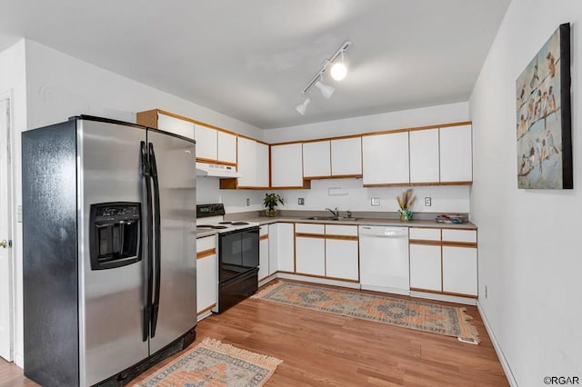 kitchen with range with electric cooktop, stainless steel fridge, dishwasher, and white cabinets