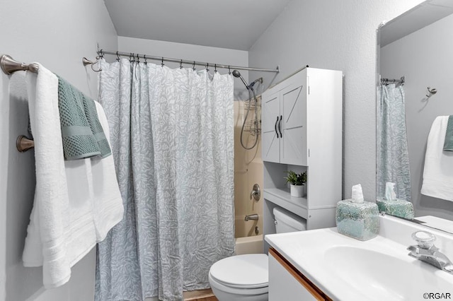 full bathroom featuring vanity, shower / bath combo, and toilet