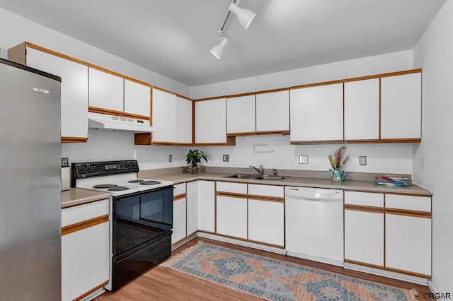 kitchen featuring white cabinetry, stainless steel fridge, dishwasher, and electric range oven