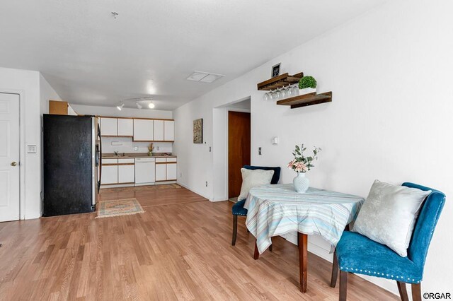 dining space with light hardwood / wood-style flooring