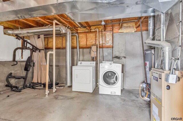 basement with separate washer and dryer and water heater