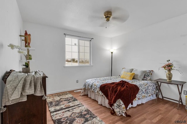 bedroom with ceiling fan and light hardwood / wood-style flooring