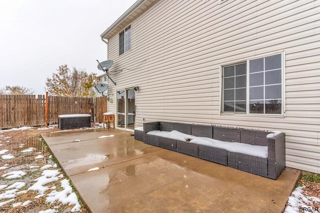 snow covered property featuring central AC and a patio area