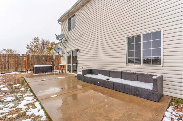 view of snowy exterior featuring a patio and central air condition unit