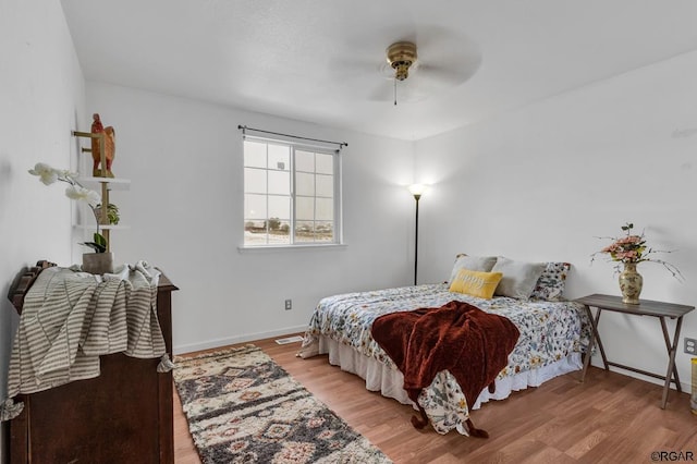 bedroom with ceiling fan and light hardwood / wood-style floors