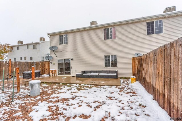 snow covered back of property featuring central air condition unit