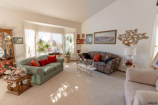 carpeted living room featuring vaulted ceiling