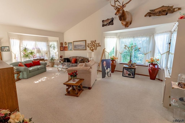 living room with lofted ceiling and light colored carpet