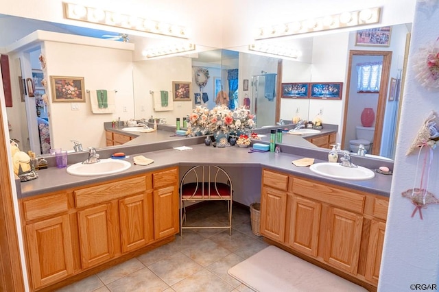 bathroom with vanity, tile patterned floors, and toilet