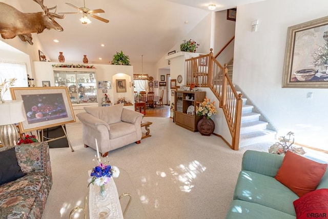 carpeted living room featuring ceiling fan and high vaulted ceiling