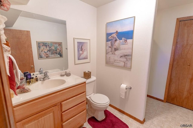 bathroom featuring vanity, tile patterned floors, and toilet