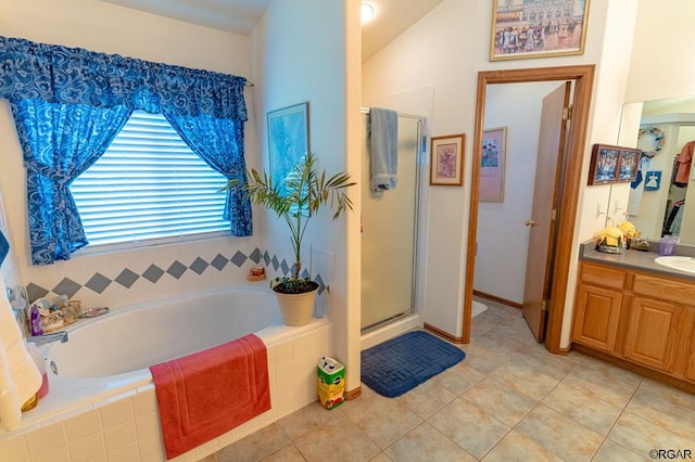 bathroom featuring tile patterned flooring, vanity, separate shower and tub, and vaulted ceiling