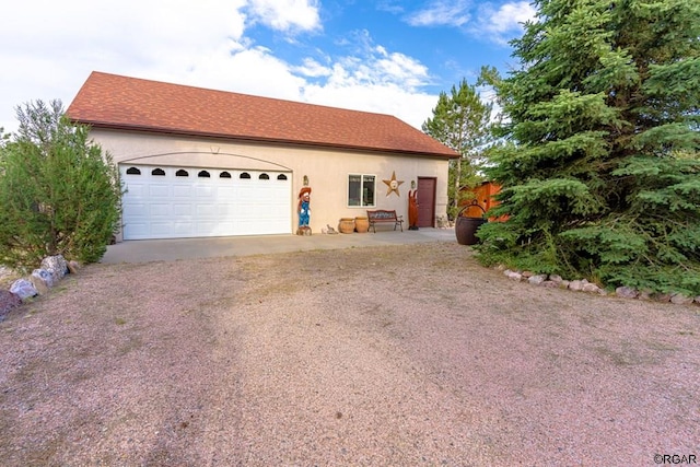 view of front of property featuring a garage and an outdoor structure