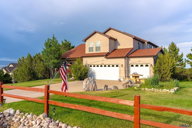 view of front of property with a garage and a front yard