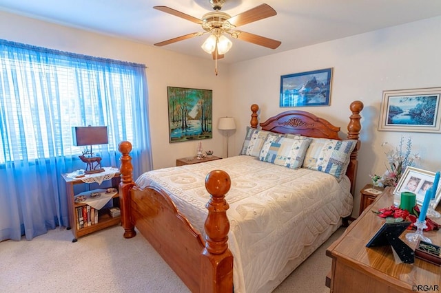 bedroom with light carpet and ceiling fan