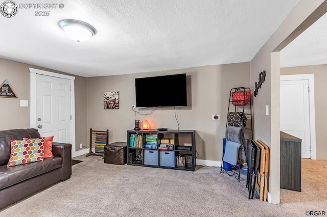 living area featuring a textured ceiling, carpet flooring, and baseboards