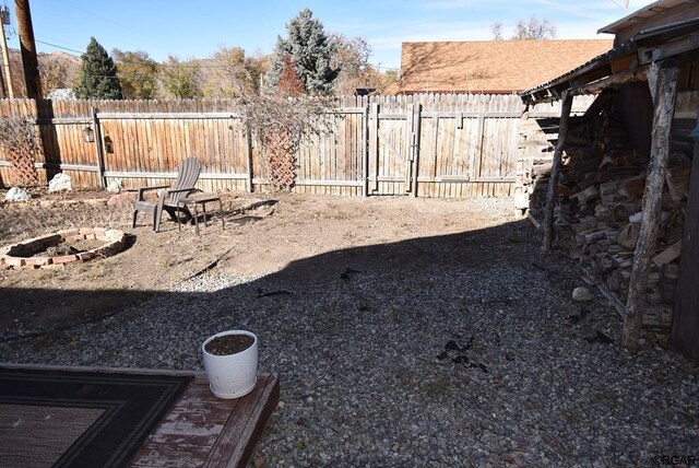 view of yard with a fire pit