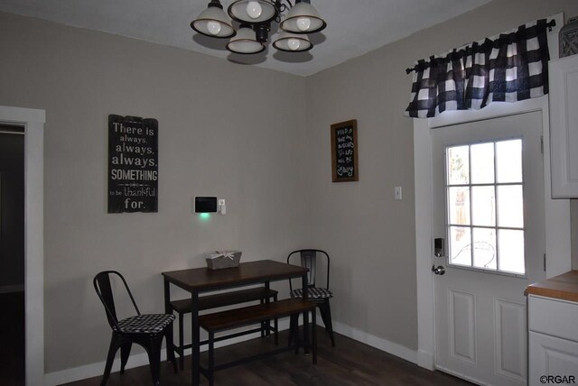 dining room featuring dark hardwood / wood-style floors and a chandelier