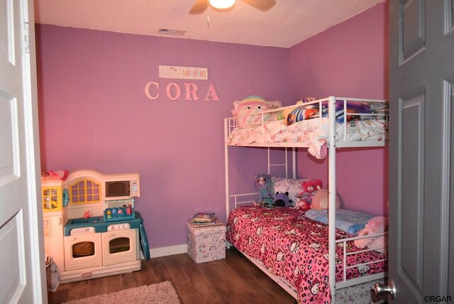 bedroom featuring dark hardwood / wood-style flooring and ceiling fan