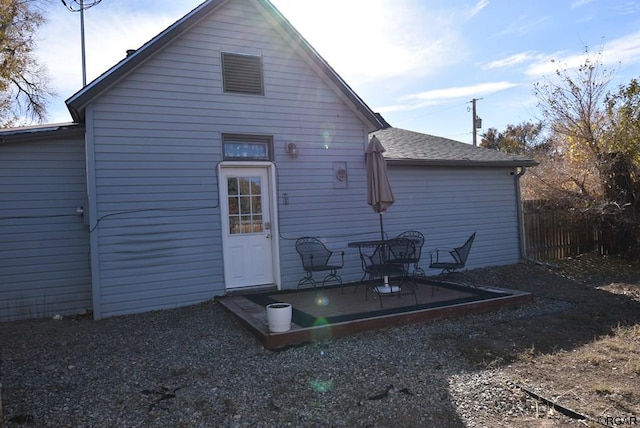 back of property with a patio