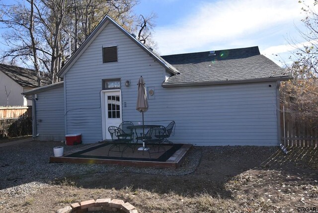 rear view of house featuring a patio area and a fire pit