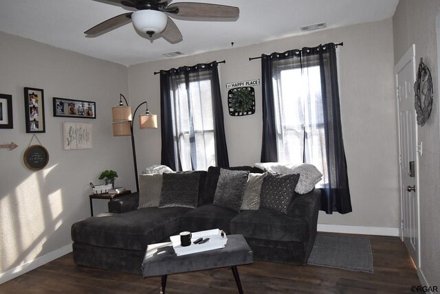 living room with dark hardwood / wood-style floors and ceiling fan