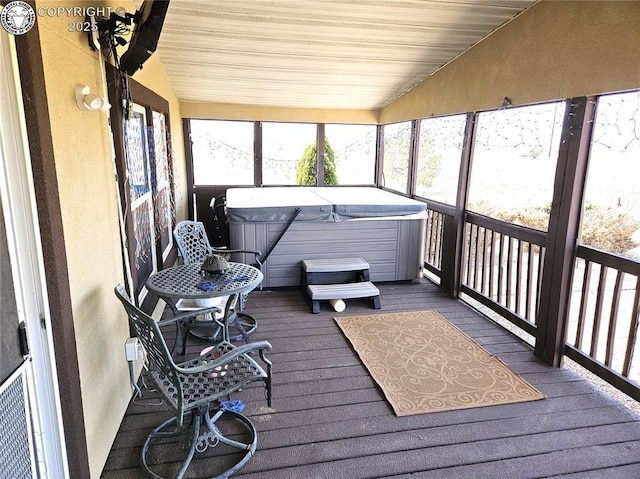 sunroom featuring a jacuzzi and lofted ceiling