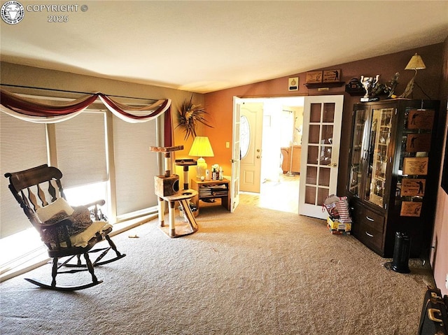 living area with carpet flooring and lofted ceiling