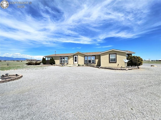 manufactured / mobile home with stucco siding and a mountain view