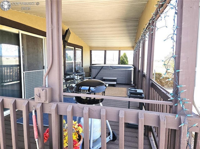 sunroom / solarium with a jacuzzi