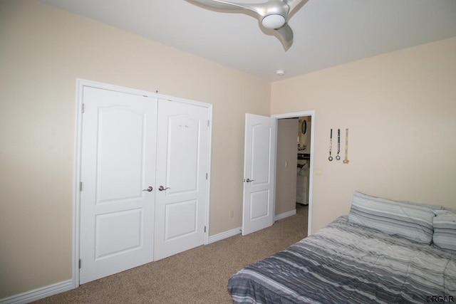 carpeted bedroom featuring ceiling fan and a closet