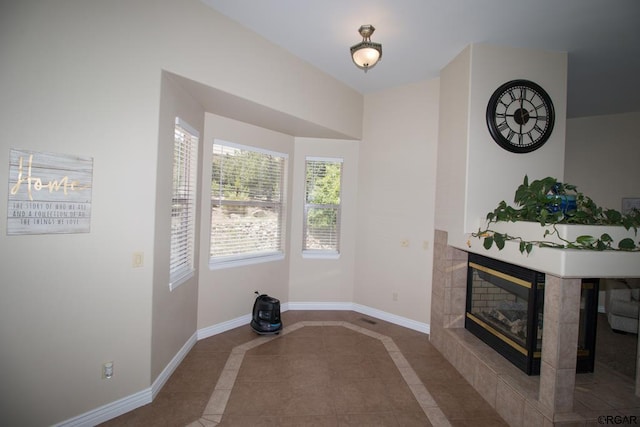 unfurnished living room featuring tile patterned floors and a tile fireplace