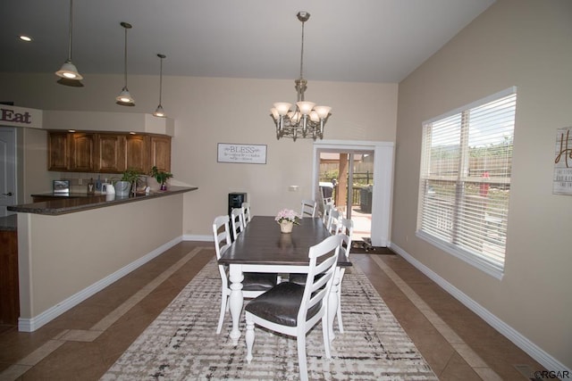 tiled dining space featuring an inviting chandelier