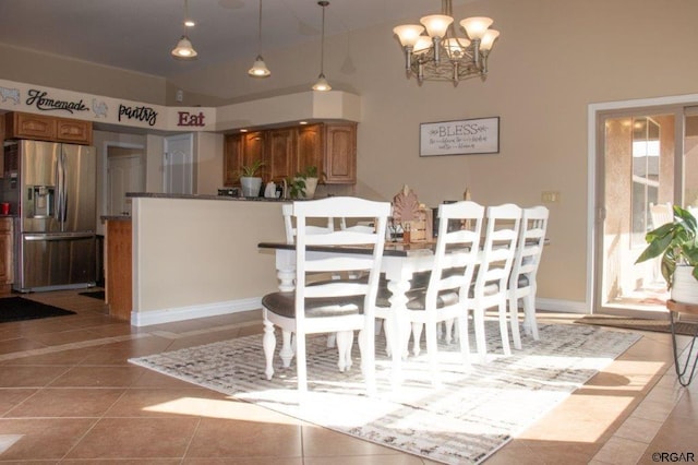 dining area featuring light tile patterned floors and a chandelier