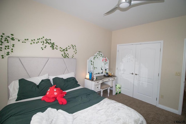 carpeted bedroom with ceiling fan and a closet