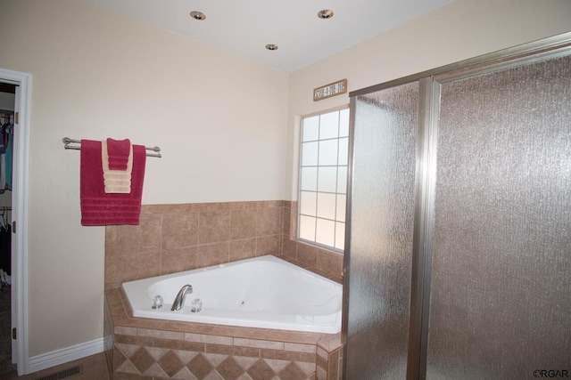 bathroom featuring separate shower and tub and a wealth of natural light