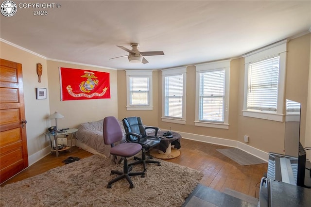 living area featuring ornamental molding, hardwood / wood-style floors, and ceiling fan