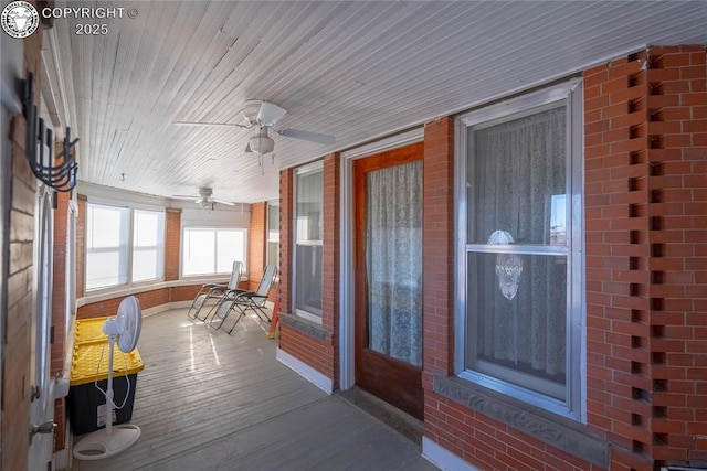 sunroom / solarium featuring ceiling fan and wooden ceiling