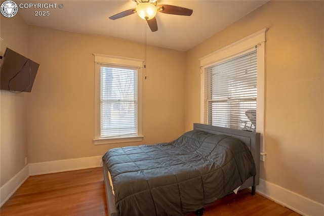 bedroom with hardwood / wood-style floors and ceiling fan