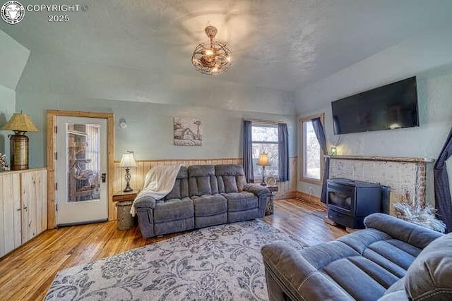 living room with a wood stove and wood finished floors