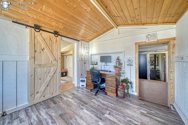 unfurnished office with wood ceiling, a barn door, lofted ceiling with beams, and wood finished floors