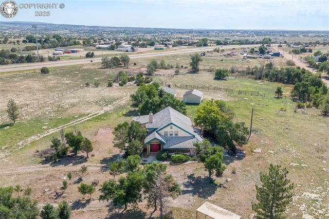 birds eye view of property with a rural view