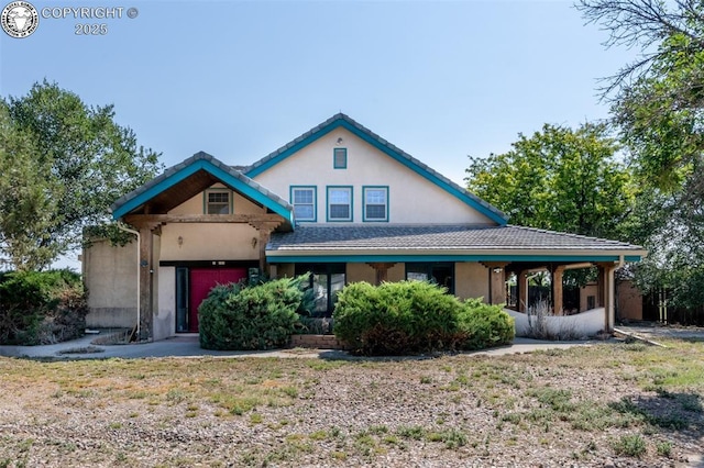 view of front of property featuring a garage and stucco siding