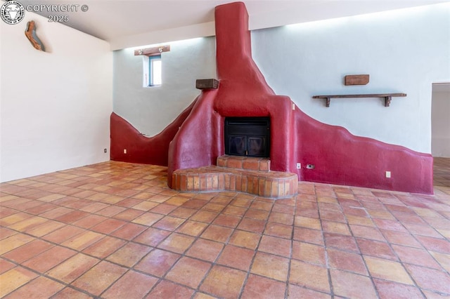 unfurnished living room featuring a wood stove