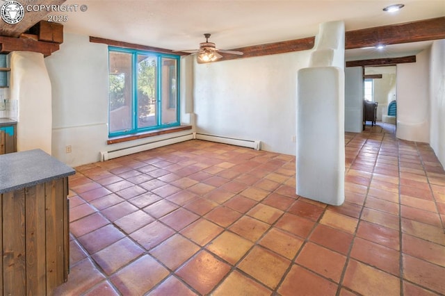 spare room with a baseboard heating unit, beam ceiling, a ceiling fan, and tile patterned floors