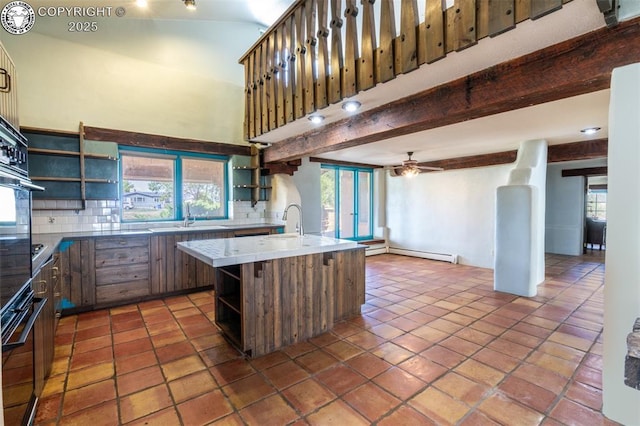 kitchen featuring open shelves, beamed ceiling, and plenty of natural light